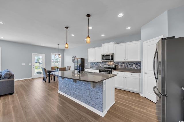 3304 Candytuft Dr, Conway, SC 29526 - kitchen featuring appliances with stainless steel finishes, dark countertops, backsplash, wood finished floors, and recessed lighting