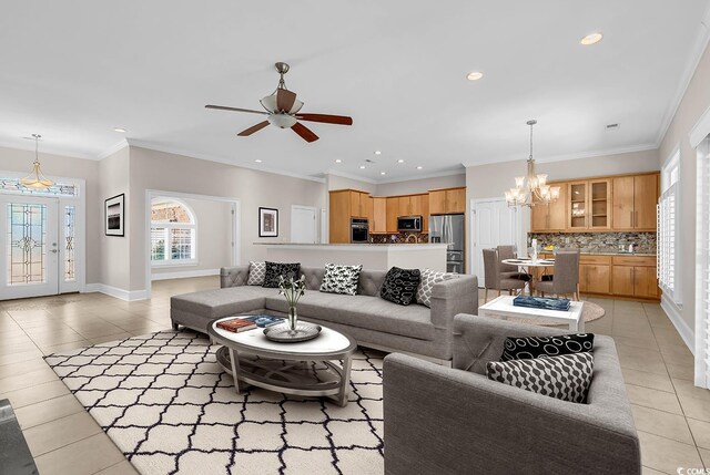 living area with baseboards, recessed lighting, light tile patterned floors, and ceiling fan with notable chandelier