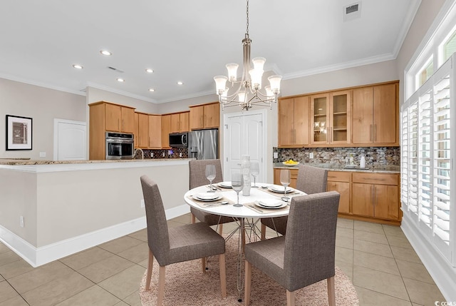 dining space featuring visible vents, light tile patterned floors, an inviting chandelier, and crown molding