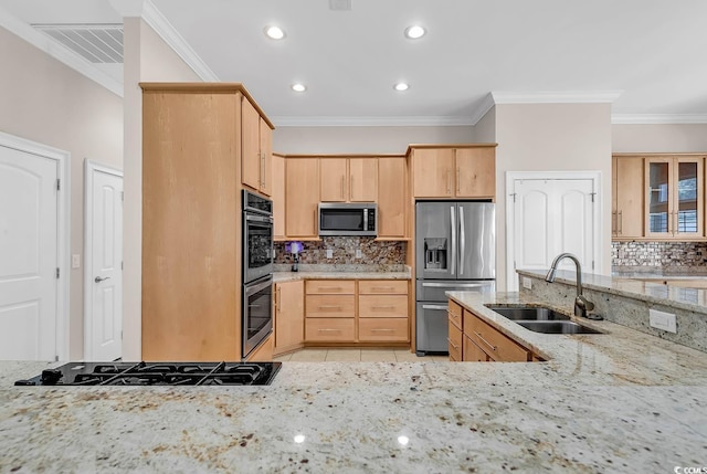 kitchen featuring a sink, tasteful backsplash, stainless steel appliances, and light brown cabinets