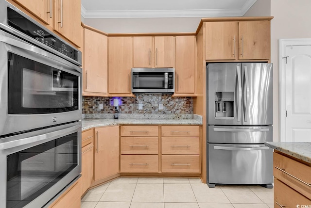 kitchen with appliances with stainless steel finishes, tasteful backsplash, light brown cabinets, and ornamental molding