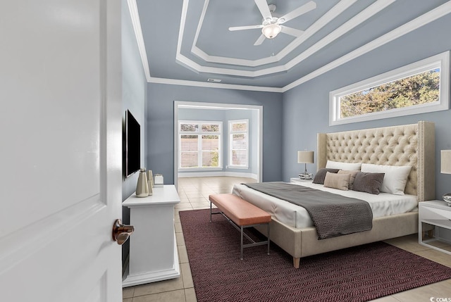 bedroom with light tile patterned floors, crown molding, and a raised ceiling
