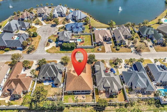 bird's eye view with a water view and a residential view