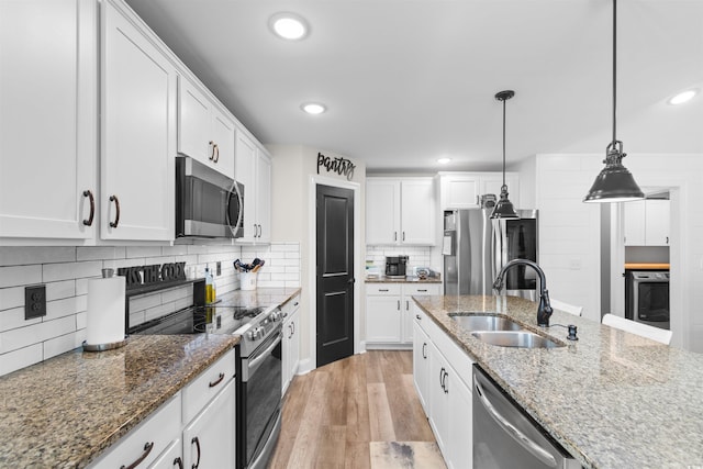 134 Winding Path Dr, Loris, SC 29569 - kitchen featuring a sink, appliances with stainless steel finishes, white cabinets, light wood-type flooring, and recessed lighting