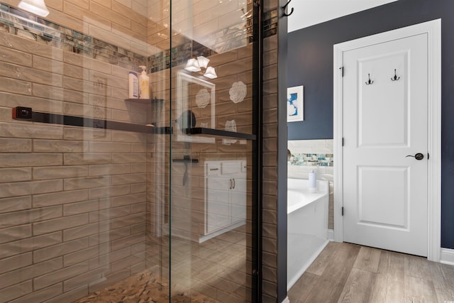 134 Winding Path Dr, Loris, SC 29569 - bathroom featuring a garden tub, a shower stall, wood finished floors, and tile walls