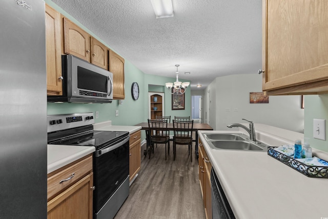 4305 Lotus Ct Unit G, Murrells Inlet, SC 29576 - kitchen with stainless steel appliances, a sink, wood finished floors, a textured ceiling, and light countertops