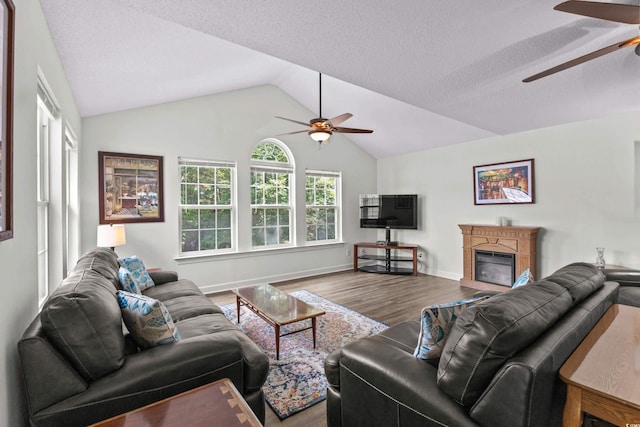 4305 Lotus Ct Unit G, Murrells Inlet, SC 29576 - living area featuring a ceiling fan, wood finished floors, vaulted ceiling, a glass covered fireplace, and baseboards