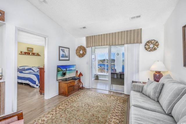 4616 Greenbriar Dr Unit H8, Little River, SC 29566 - living area featuring wood finished floors, vaulted ceiling, and a textured ceiling