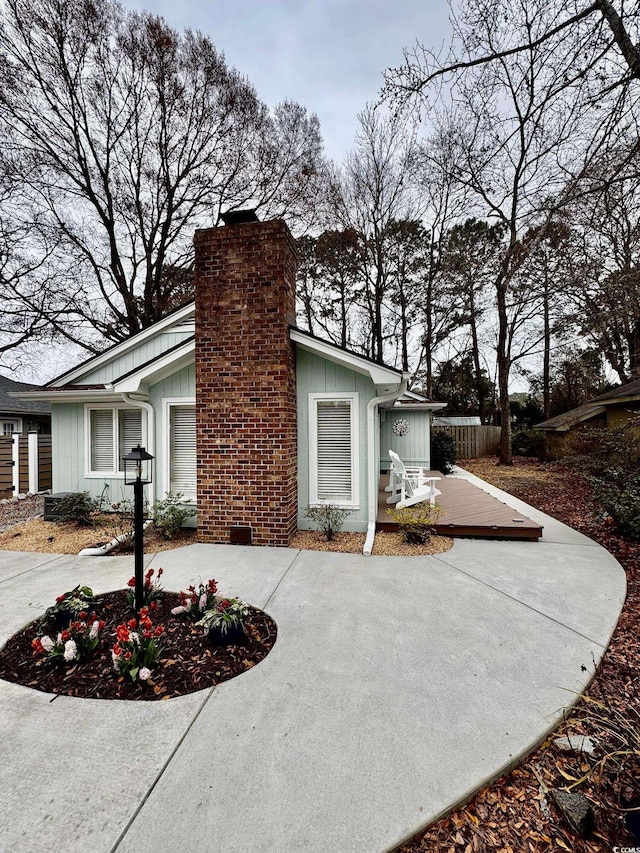 view of side of home with a chimney