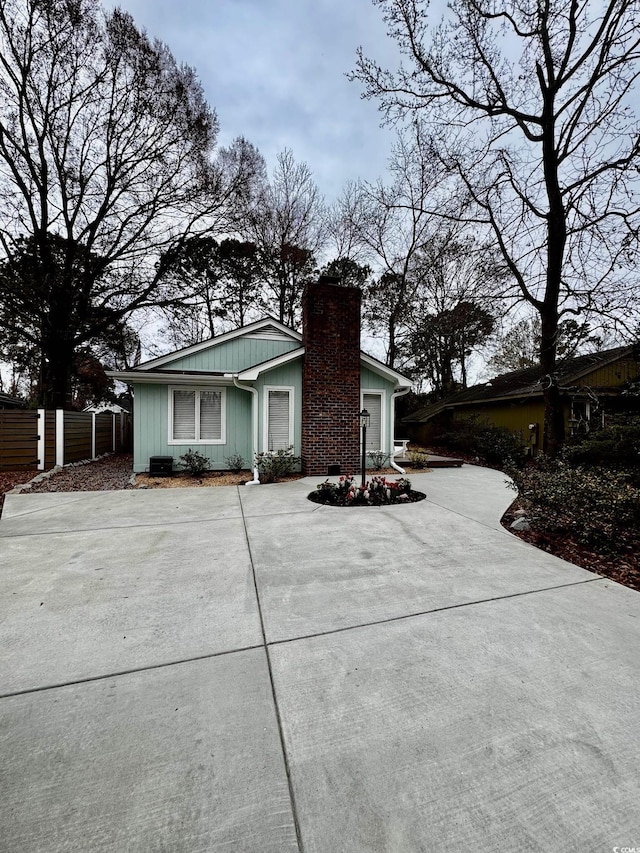 view of front of property featuring fence and a chimney