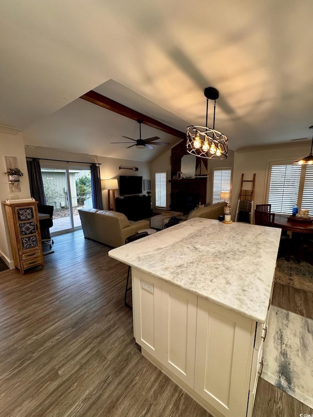 kitchen with a ceiling fan, decorative light fixtures, dark wood-style flooring, lofted ceiling with beams, and white cabinets