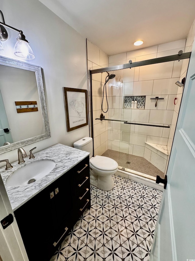 full bathroom with a stall shower, toilet, and vanity