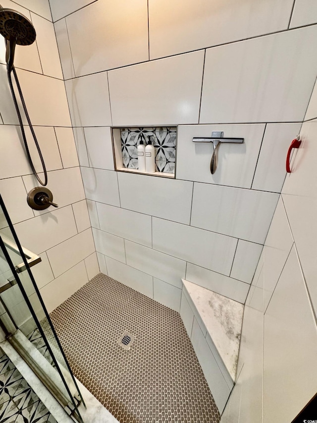 bathroom with a tile shower