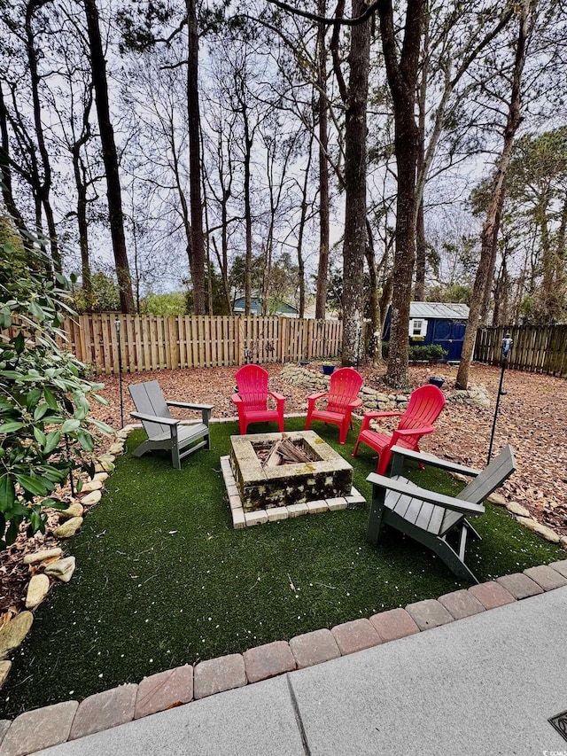 view of yard featuring a fire pit and fence private yard