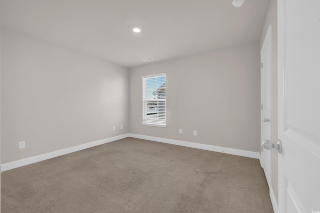 carpeted empty room with baseboards and recessed lighting