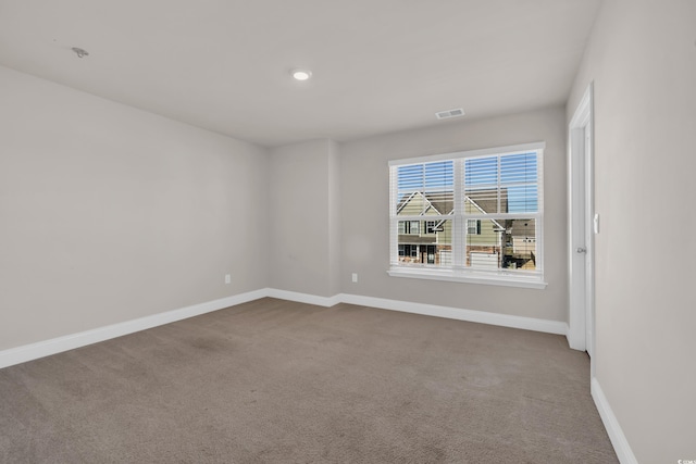 carpeted spare room featuring baseboards and recessed lighting