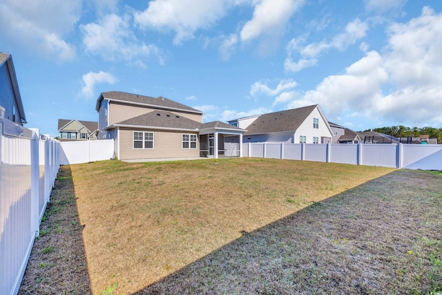 view of yard with a sunroom and a residential view