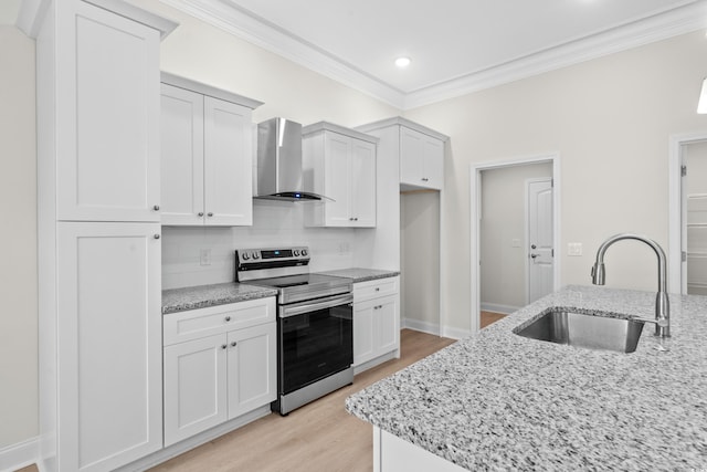 kitchen featuring stainless steel range with electric cooktop, wall chimney range hood, a sink, ornamental molding, and backsplash