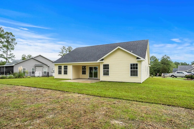 back of house featuring a patio and a shingled roof