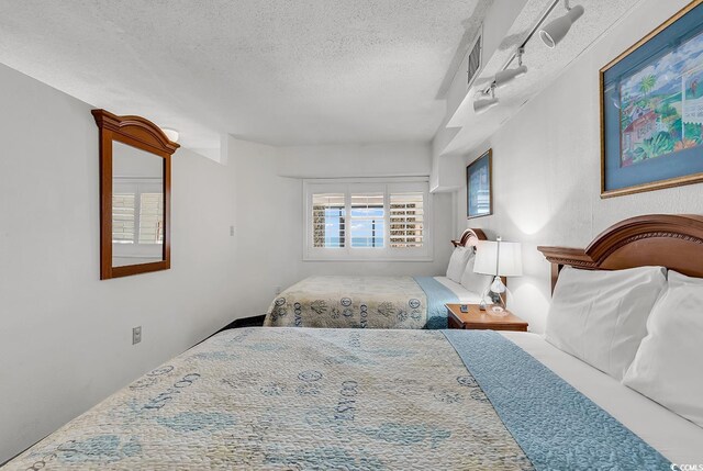 bedroom featuring visible vents and a textured ceiling