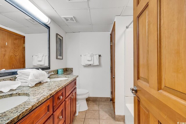 full bath featuring tile patterned flooring, visible vents, a paneled ceiling, and a sink