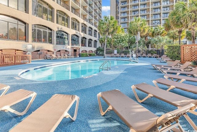 pool featuring a patio and fence