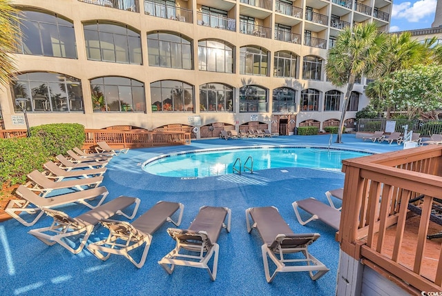 community pool with a patio area