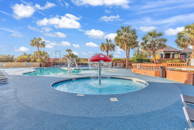 community pool with a patio and fence