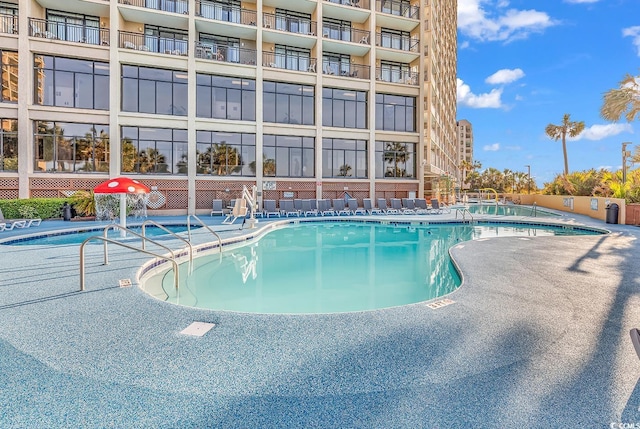 community pool featuring a patio area