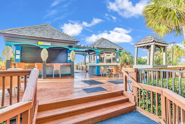 wooden terrace featuring a gazebo