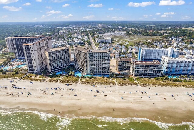 birds eye view of property featuring a water view, a city view, and a view of the beach