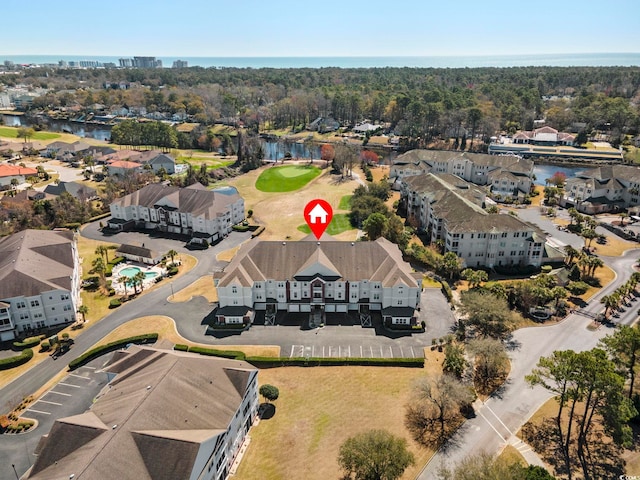 aerial perspective of suburban area with a nearby body of water and a golf club