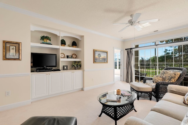 living room featuring crown molding, ceiling fan, light colored carpet, a textured ceiling, and baseboards