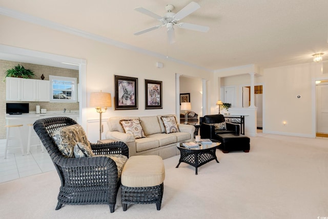 living room featuring a ceiling fan, light carpet, and crown molding