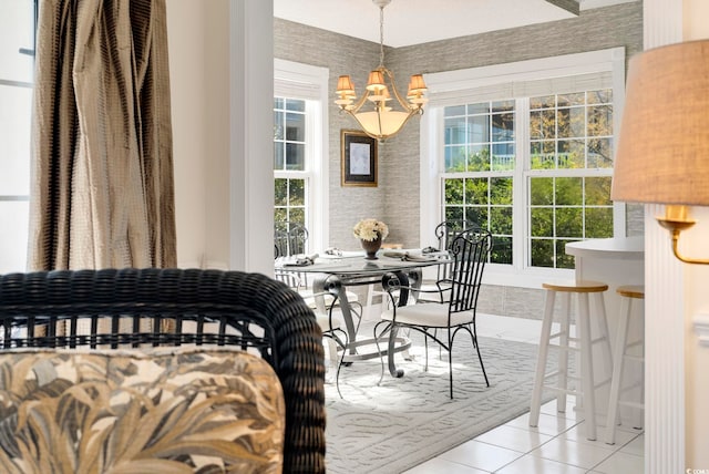 dining space featuring light tile patterned flooring and a chandelier