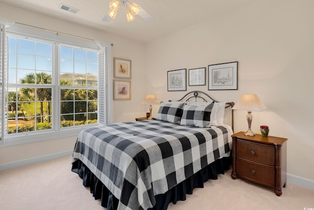 bedroom featuring light carpet, baseboards, and ceiling fan