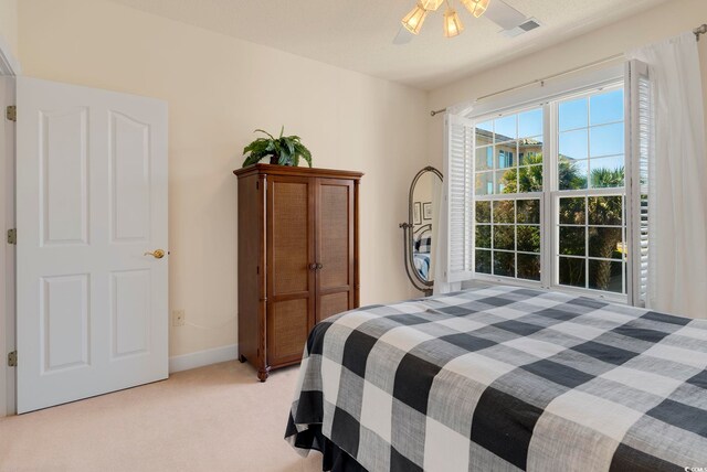 2241 Waterview Dr Unit 425, North Myrtle Beach, SC 29582 - bedroom with light colored carpet, baseboards, and a ceiling fan