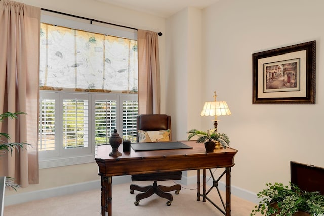 carpeted home office featuring baseboards