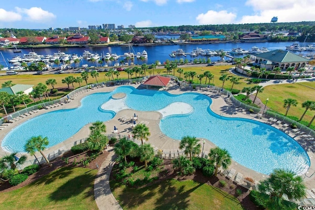 aerial view of property's location featuring a large body of water, a marina, and a pool area