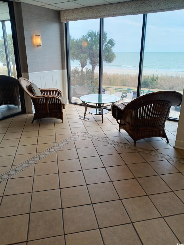 sunroom with a beach view and a water view