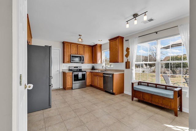 2629 Scarecrow Way, Myrtle Beach, SC 29579 - kitchen featuring stainless steel appliances, light countertops, healthy amount of natural light, and decorative backsplash