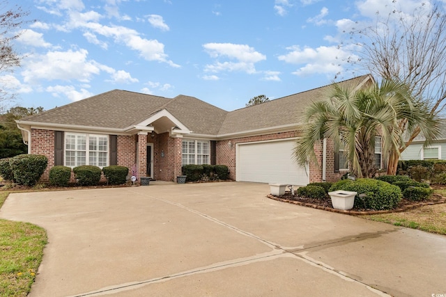 single story home featuring roof with shingles, concrete driveway, a garage, and brick siding