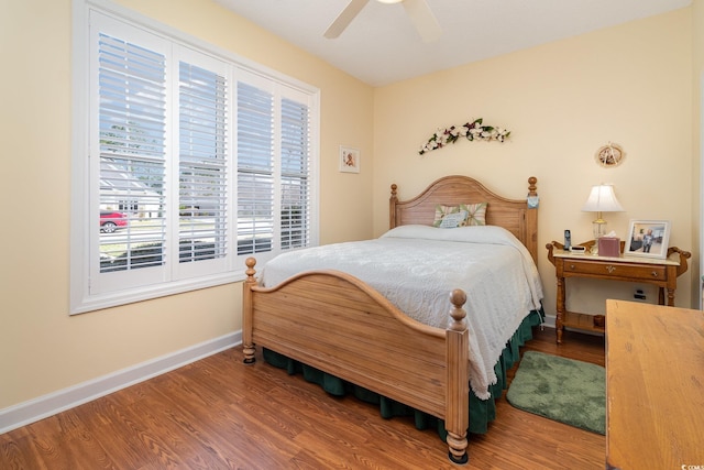 bedroom featuring baseboards, ceiling fan, and wood finished floors