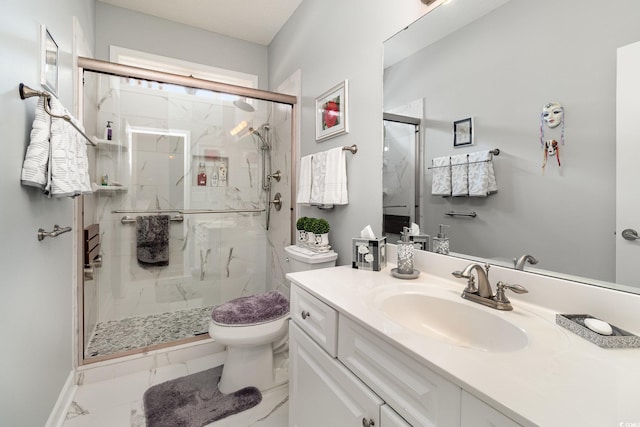 bathroom with a marble finish shower, marble finish floor, vanity, and toilet