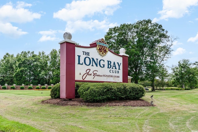 community / neighborhood sign with a lawn