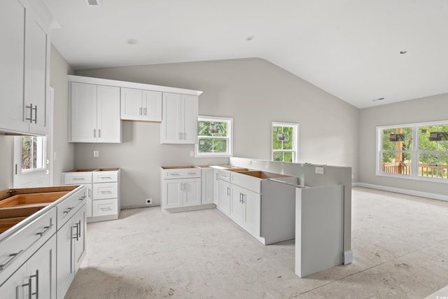 3566 Steamer Trace Rd, Conway, SC 29527 - kitchen with vaulted ceiling, a peninsula, and white cabinets
