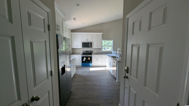 3566 Steamer Trace Rd, Conway, SC 29527 - kitchen with a sink, appliances with stainless steel finishes, lofted ceiling, dark wood finished floors, and white cabinetry