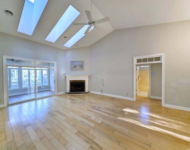 414 Dornoch Dr, Pawleys Island, SC 29585 - unfurnished living room with a brick fireplace, light wood finished floors, and visible vents