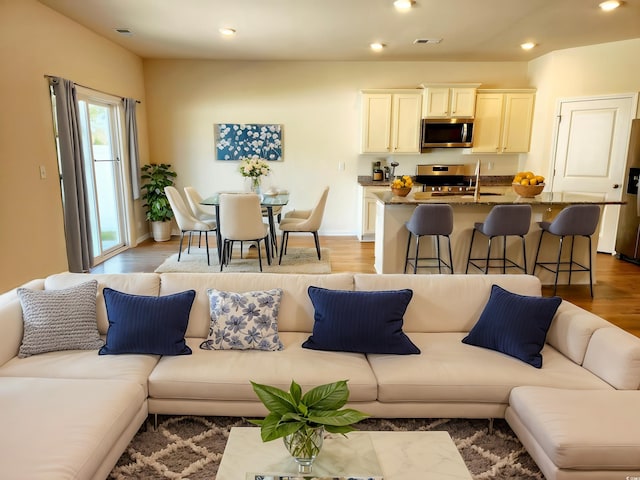 5088 Wavering Place Loop, Myrtle Beach, SC 29579 - living room with recessed lighting, wood finished floors, and baseboards