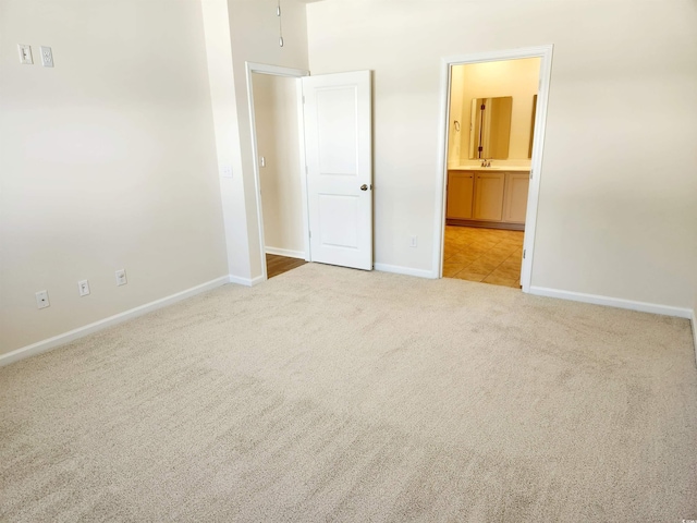 5088 Wavering Place Loop, Myrtle Beach, SC 29579 - unfurnished bedroom with carpet floors, baseboards, ensuite bath, and a sink